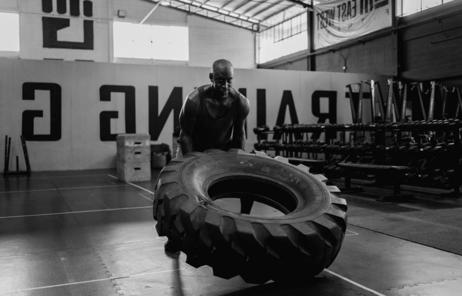 Athlete working through foundational handstand position on training floor